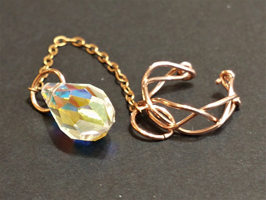 braided copper ear cuff with chain with faceted crystal drop, no piercing needed, showcasing intricate hand-braided design and rustic boho aesthetic from BeetleBee Designs.