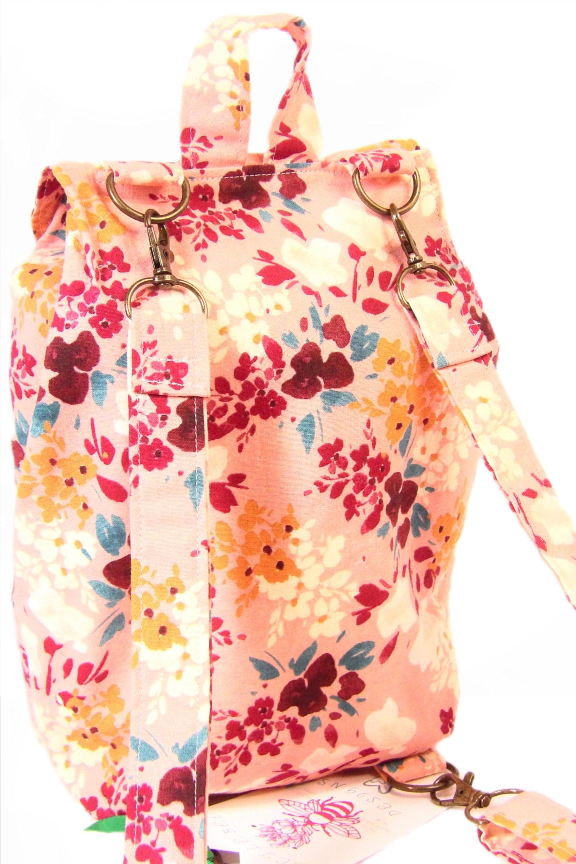 convertible mini backpack purse for women with wildflower cotton fabric. Convertible backpack purse that can be worn as a sling bag. Boho style mini backpack photo of the back. Bohemian floral fabric