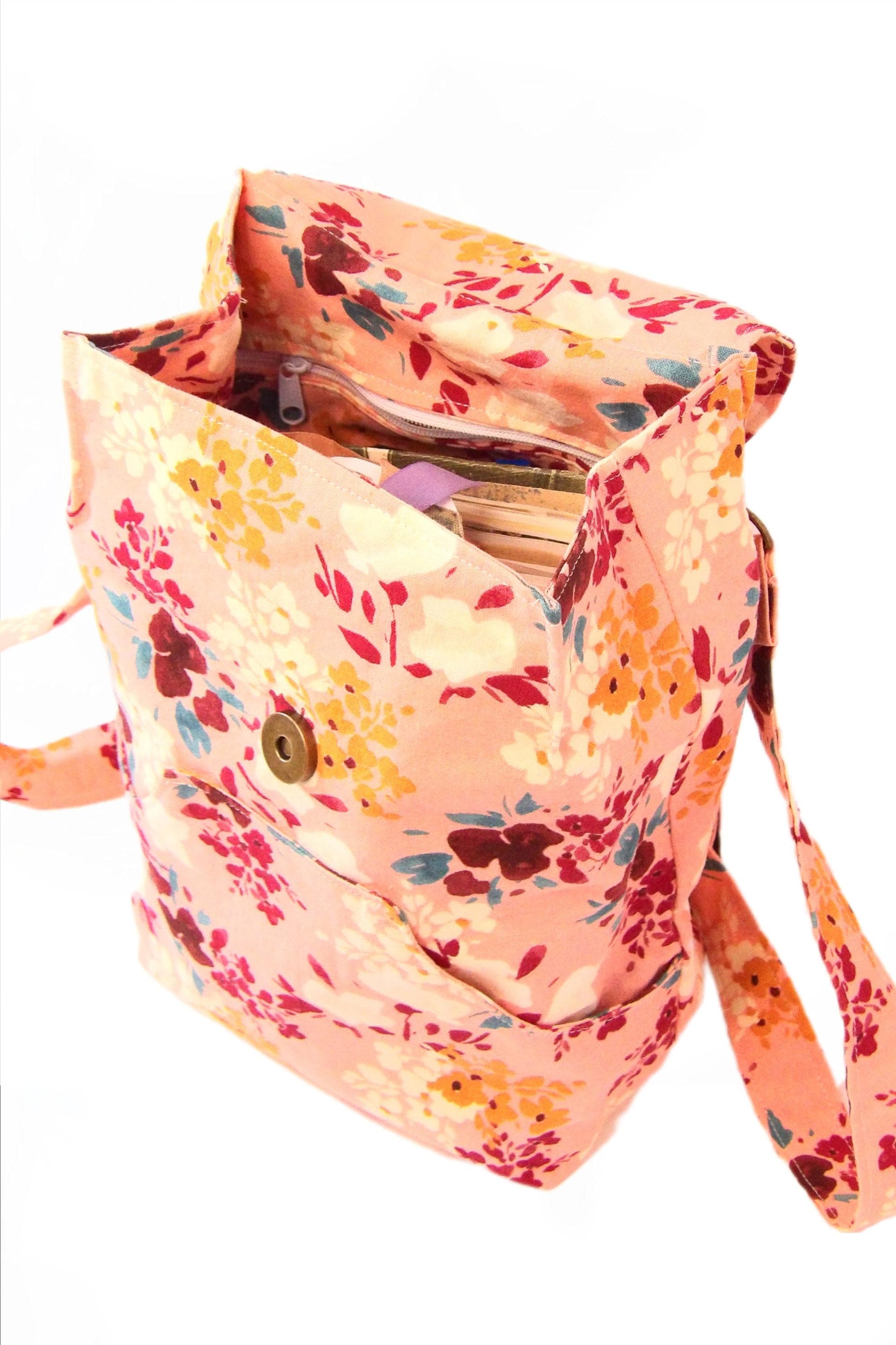 convertible mini backpack purse for women with wildflower cotton fabric. Convertible backpack purse that can be worn as a sling bag. Boho style mini backpack photo of the top being open. Bohemian floral fabric