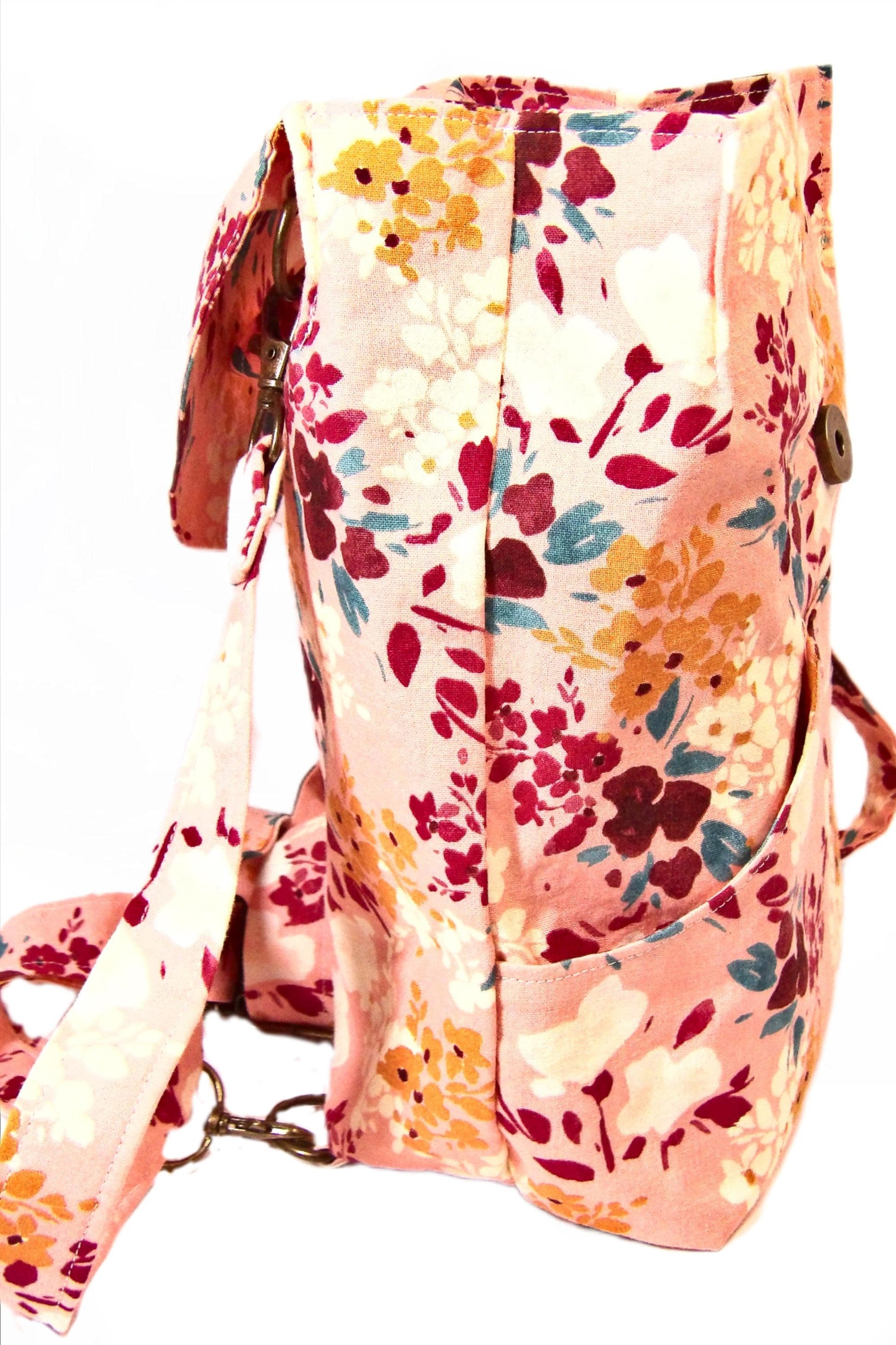 convertible mini backpack purse for women with wildflower cotton fabric. Convertible backpack purse that can be worn as a sling bag. Boho style mini backpack photo of the side. Bohemian floral fabric