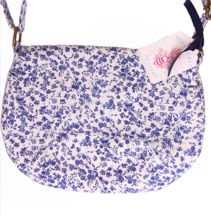 close up of blue and white floral fabric crossbody bag with whimsical butterfly motifs. Lightweight boho crossbody bag with enchanting flower fabric perfect for festivals and outings