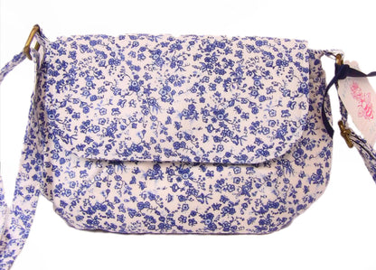 close up of blue and white floral fabric crossbody bag with whimsical butterfly motifs. Lightweight boho crossbody bag with enchanting flower fabric perfect for festivals and outings