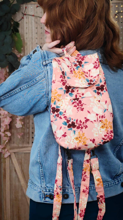 convertible mini backpack purse for women with floral cotton fabric. Convertible backpack purse that can be worn as a sling bag. Boho style mini backpack on model