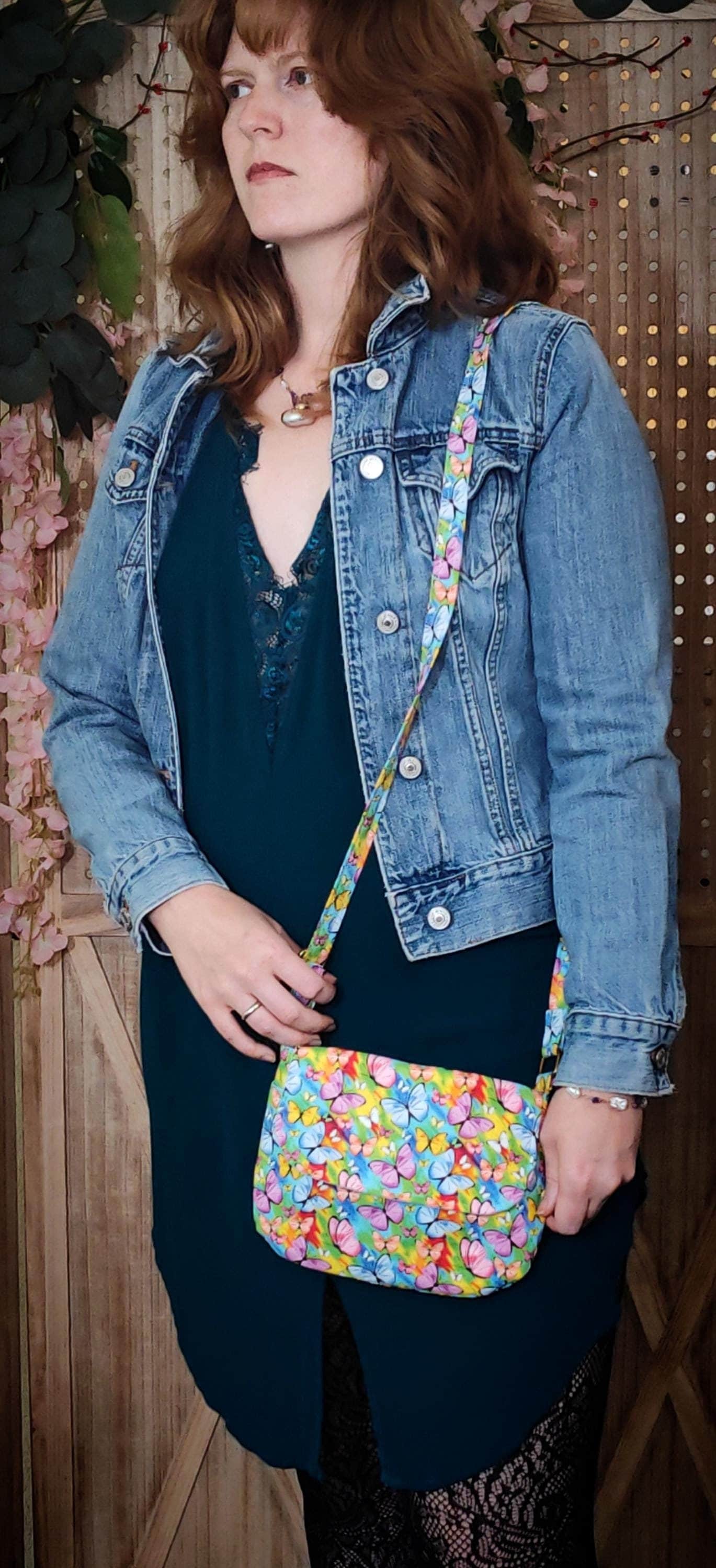 crossbody fabric purse with colorful rainbow butterfly design perfect for festivals or day trips. Model wearing lightweight crossbody bag with rainbow butterfly fabric in a bohemian style