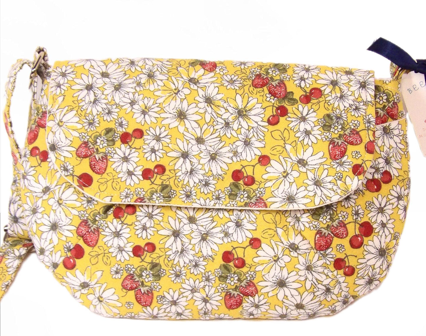 close up closed view of a daisy fabric crossbody bag with bohemian style cherries and strawberries, lightweight crossbody purse with a whimsical floral print. Cotton fabric boho bag perfect for festivals and outdoor adventures