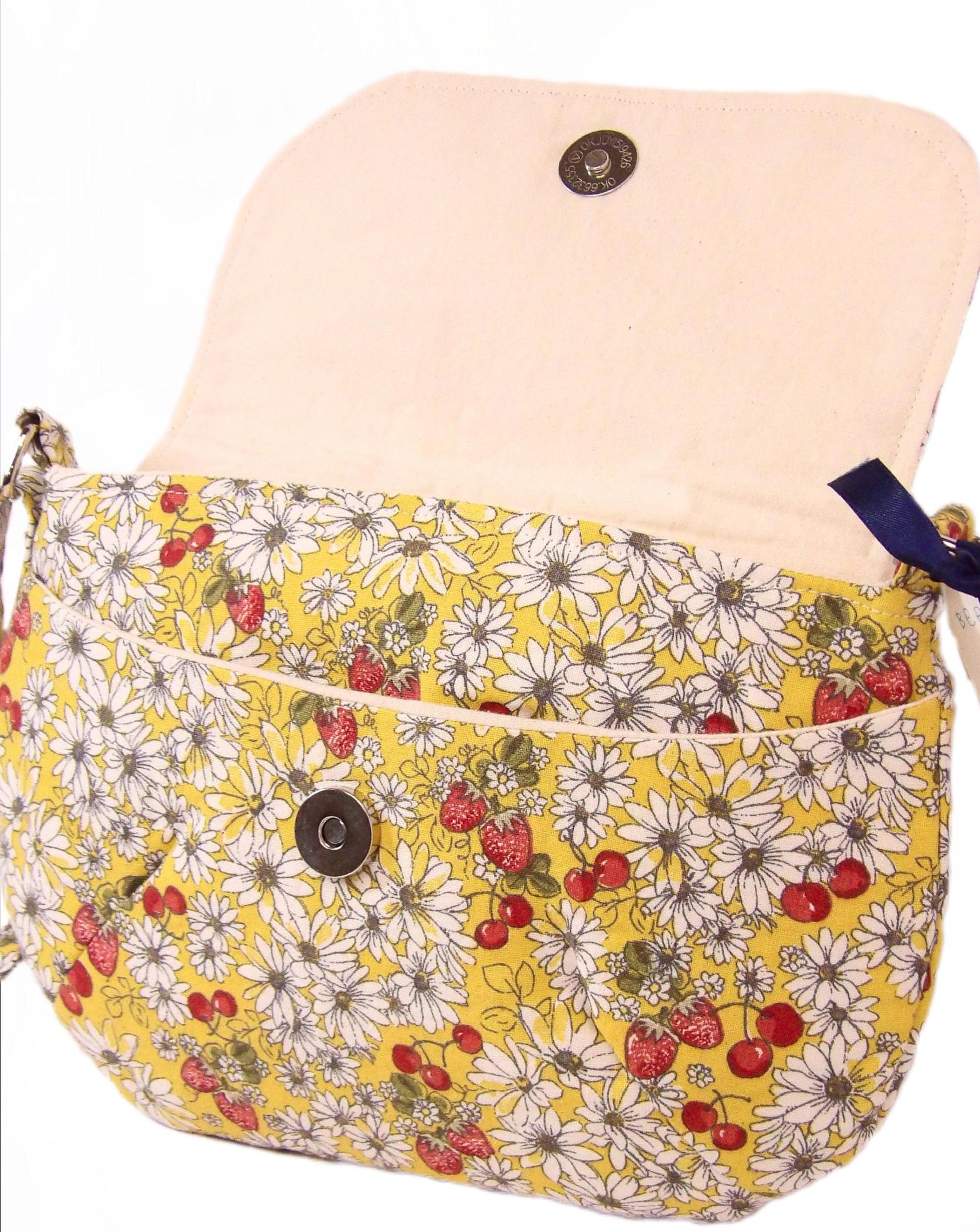 open view of a daisy fabric crossbody bag with bohemian style cherries and strawberries, lightweight crossbody purse with a whimsical floral print. Cotton fabric boho bag perfect for festivals and outdoor adventures