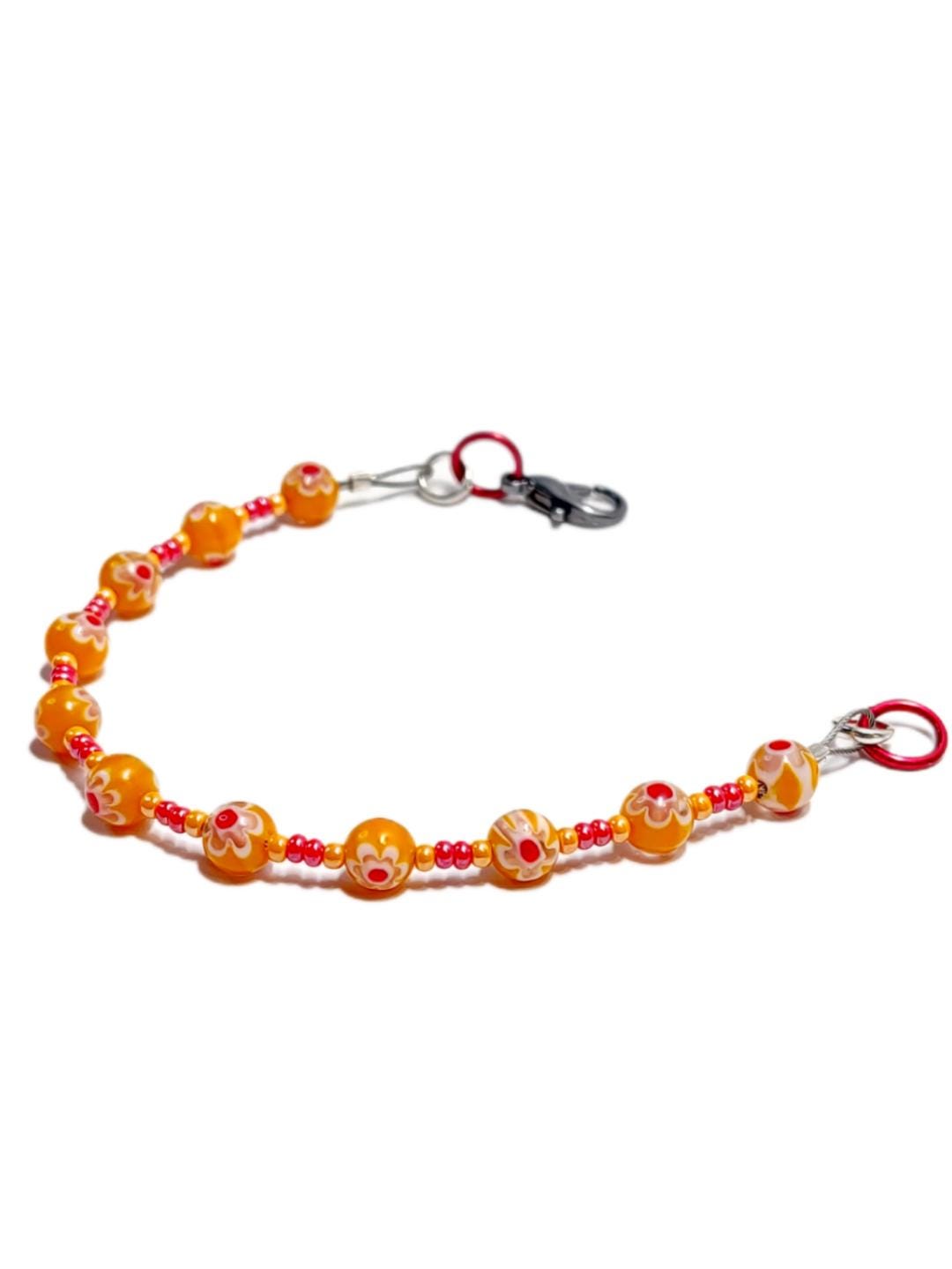 millefiori glass bracelet made with floral mosaic beads in orange and red. Bohemian style jewelry