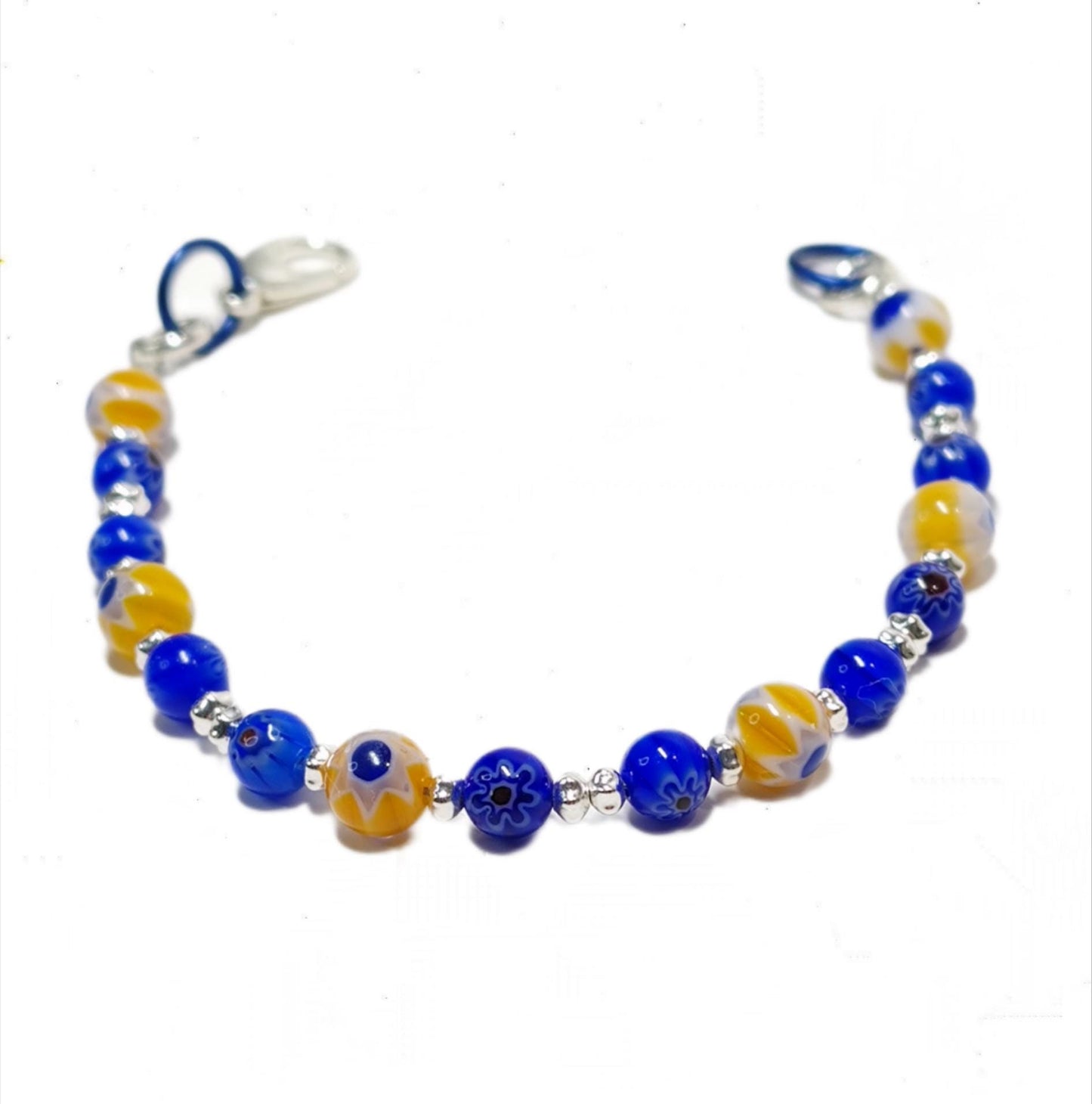 blue and yellow mosaic glass bracelet made with floral millefiori and star place spacer beads in a bohemian style.