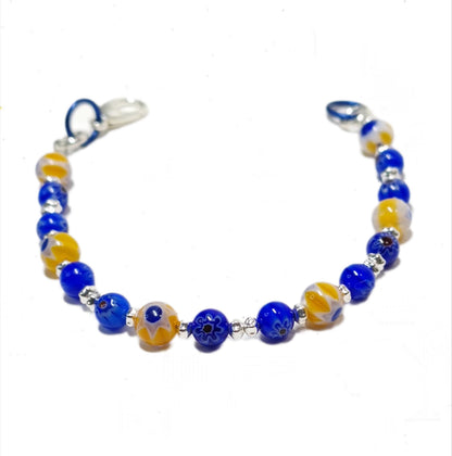 blue and yellow mosaic glass bracelet made with floral millefiori and star place spacer beads in a bohemian style.