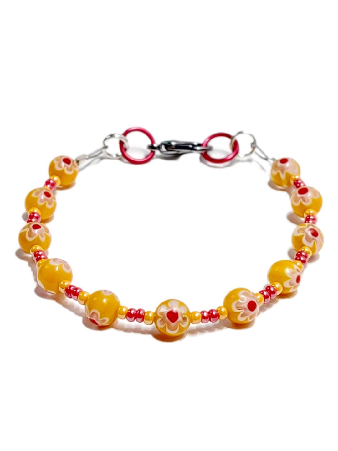 millefiori glass bracelet made with floral mosaic beads in orange and red. Bohemian style jewelry