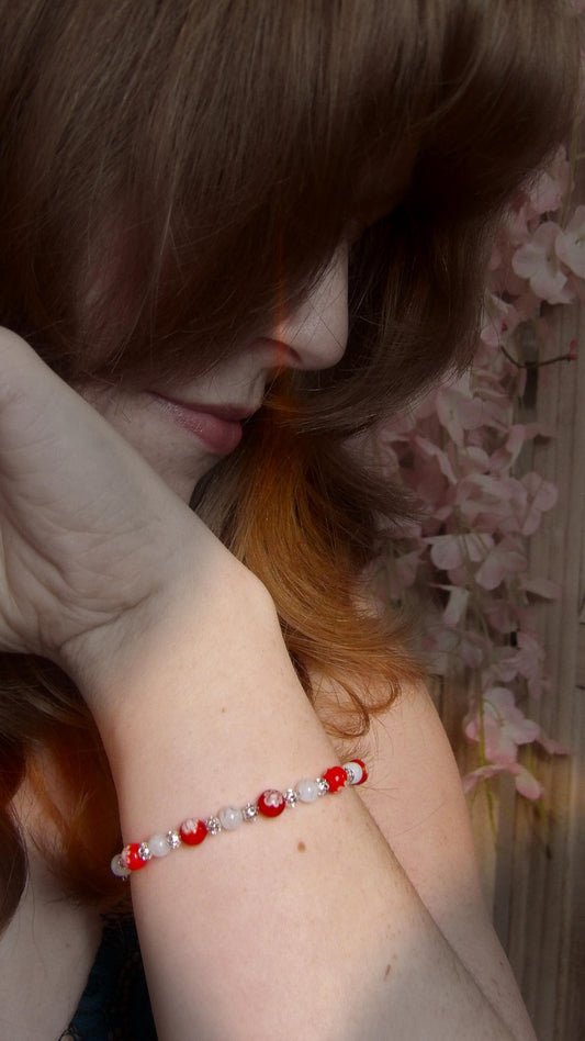 model wearing millefiori glass beaded bracelet with silver accent beads in a bohemian style. Handmade bracelet from the pacific northwest, USA