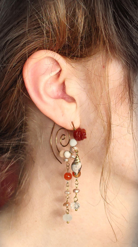 Beaded spiral hoop earrings with aquamarine, pearls and red agates. Hammered bronze frames with carved red agate roses and hand beaded fringe consisting of pearls and aquamarines. Shell charm adorns each frame. Bohemian ethereal elegance perfect for date nights and festival events.