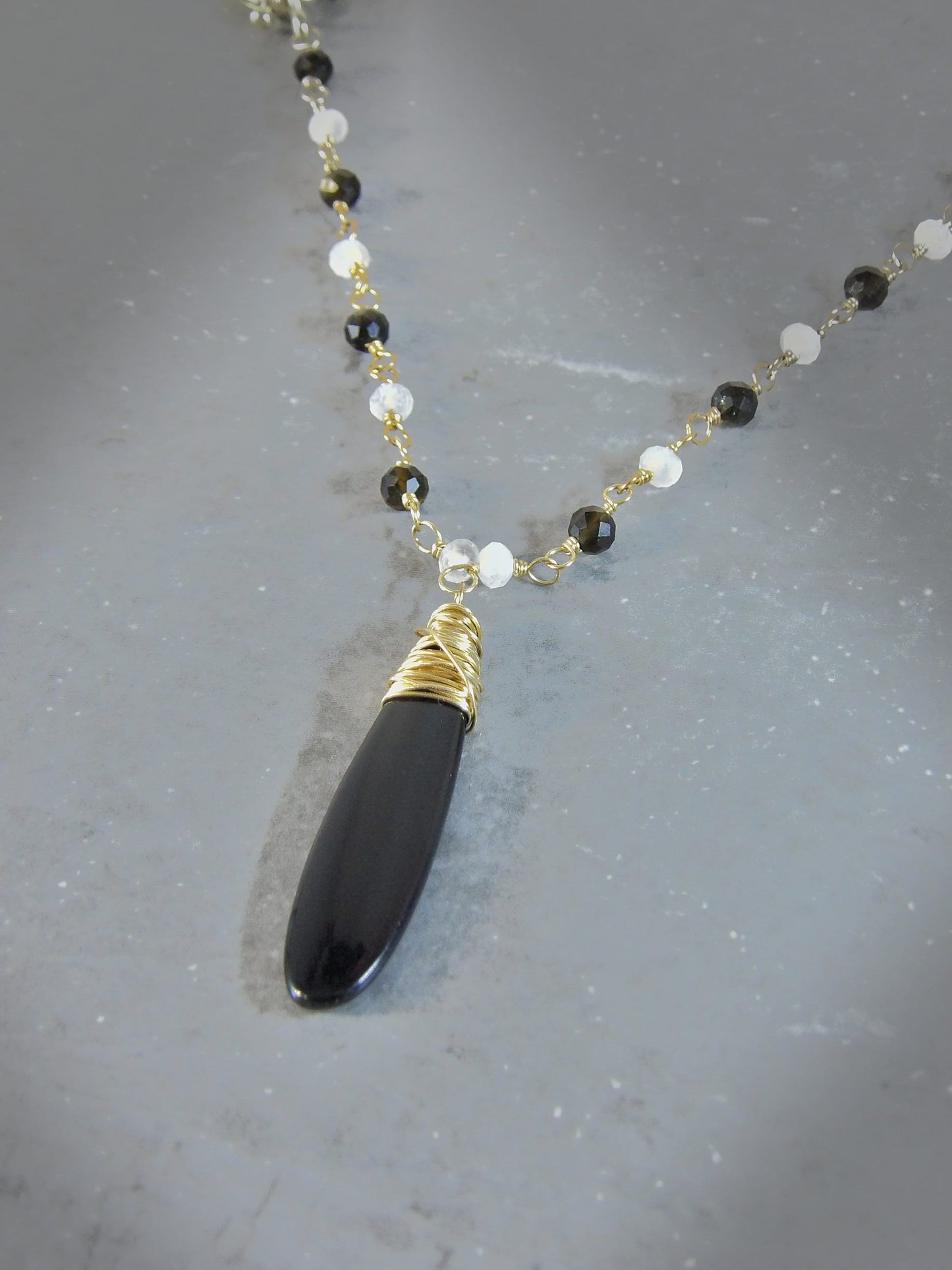 Hammered brass obsidian & moonstone torque necklace