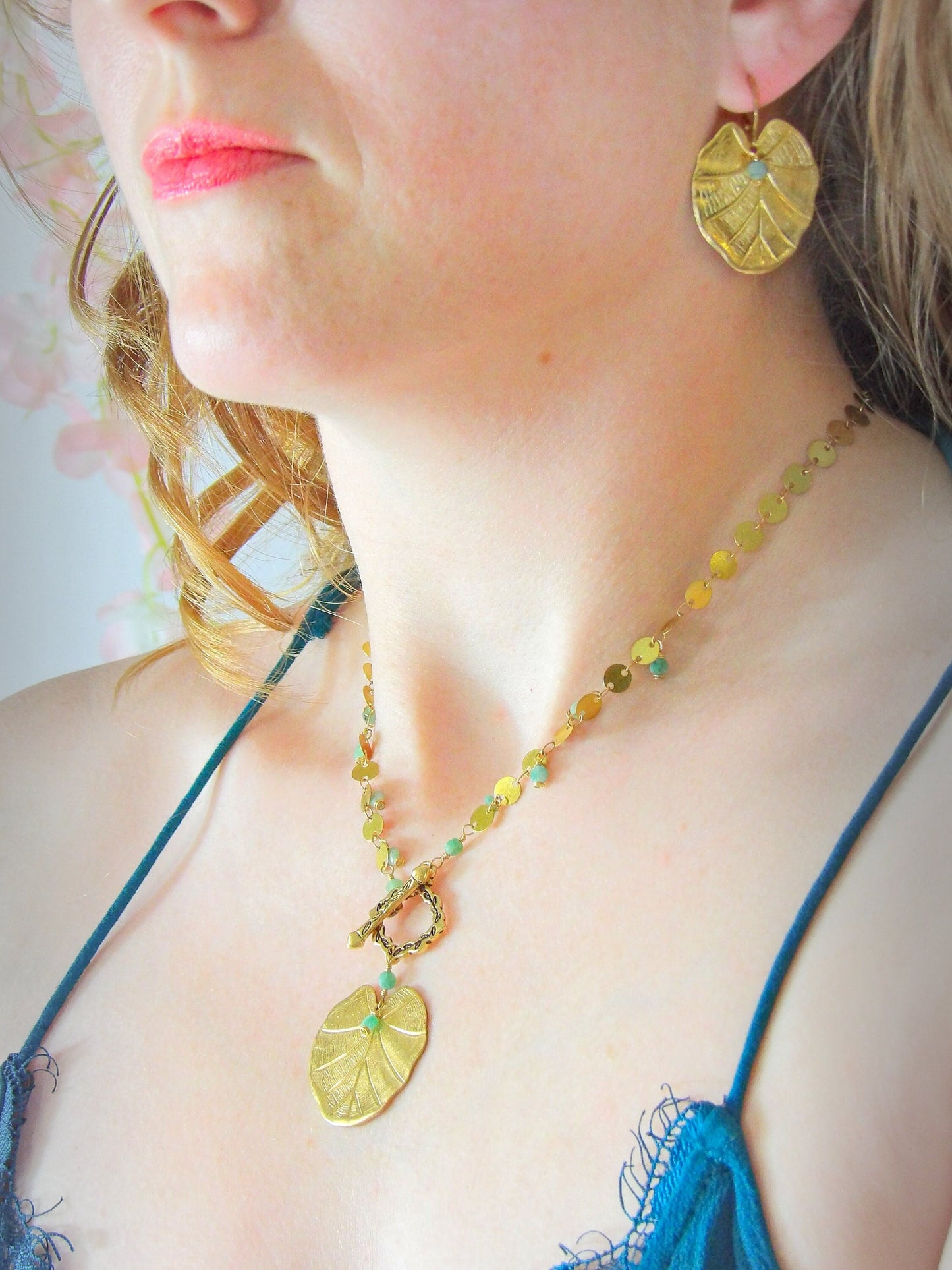 emerald earrings with large leaf charm. boho earrings with leaf charm and natural emerald. raw crystal emerald earrings